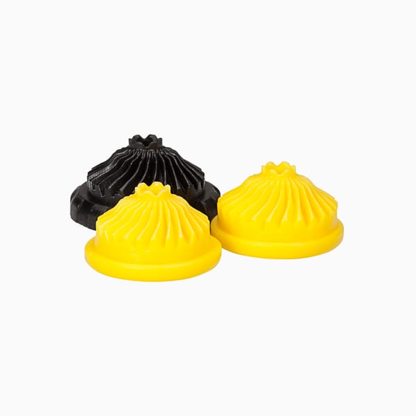 Black and yellow internal sprinkler components injection molded by Xcentric